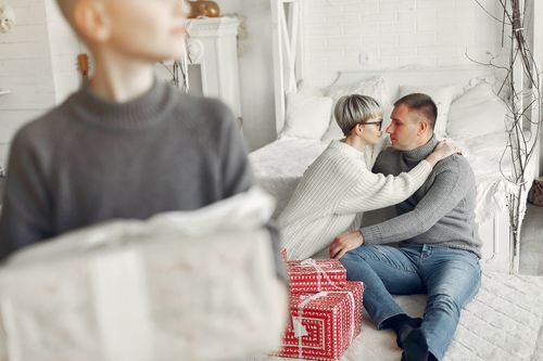 Free Family time in a cozy bedroom with Christmas gifts, capturing warmth and togetherness. Stock Photo