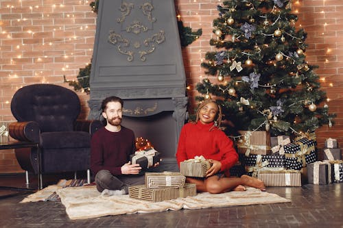 Couple with Presents under Christmas Tree