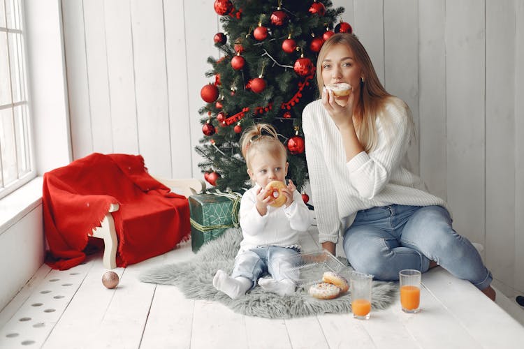 Mother And Daughter Eating Donuts