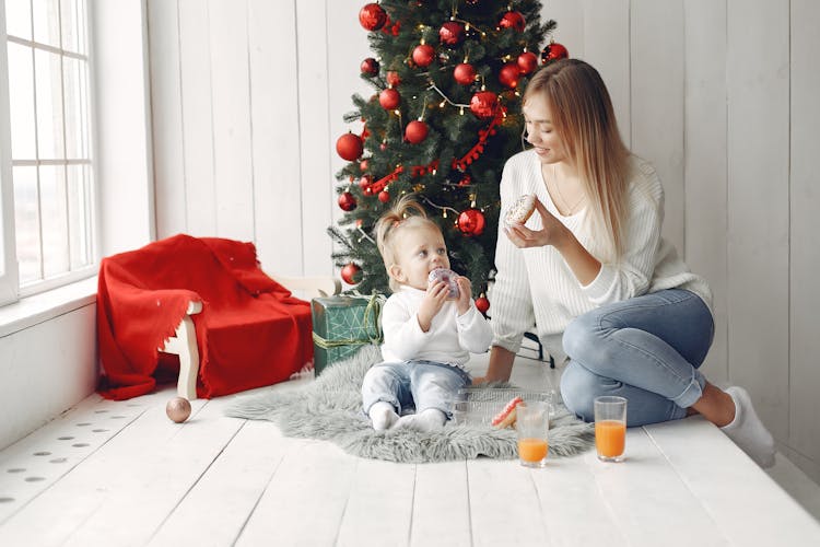 Mother And Daughter Eating Donuts