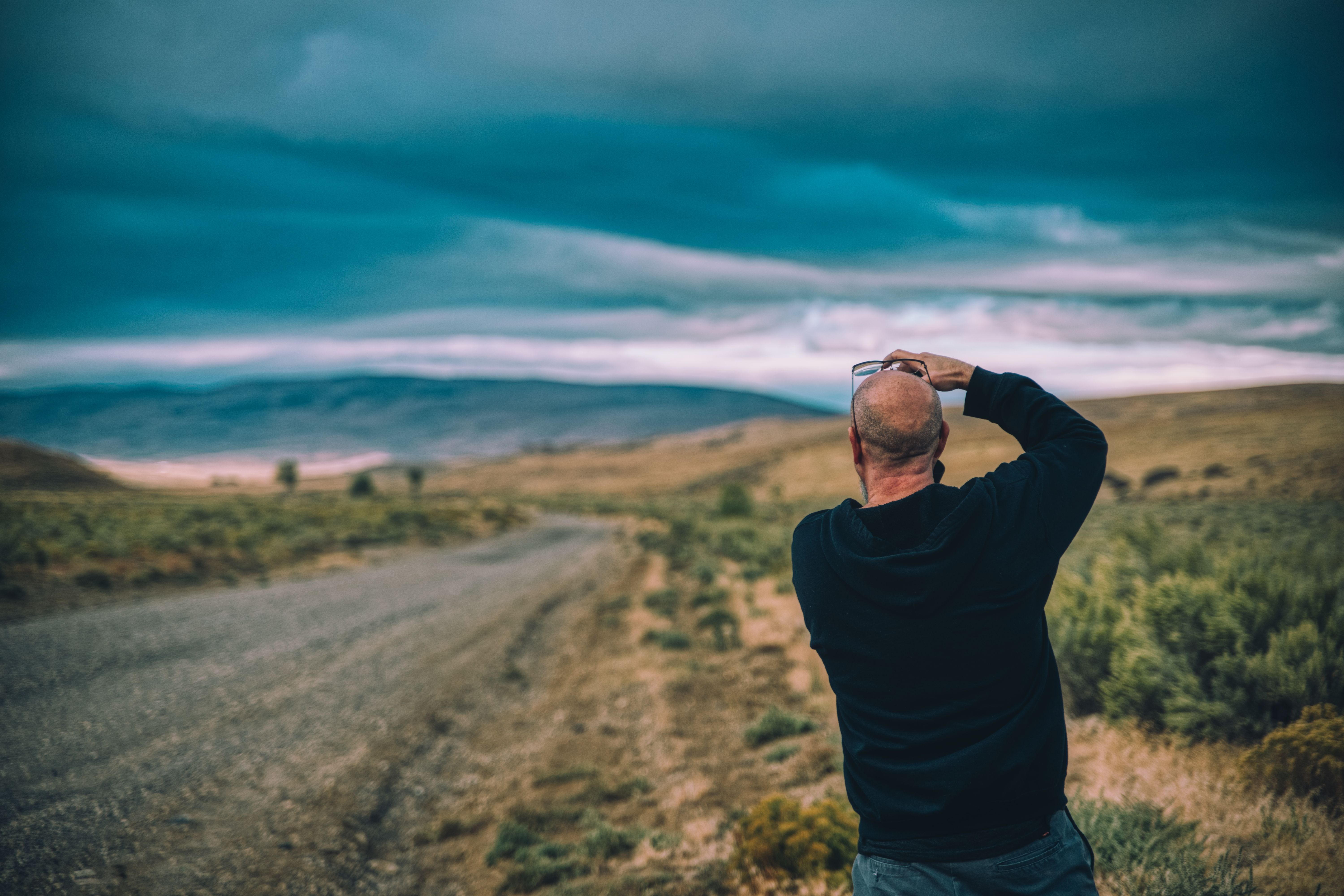 Back View Shot of a Man Taking Photos of the Scenery · Free Stock Photo