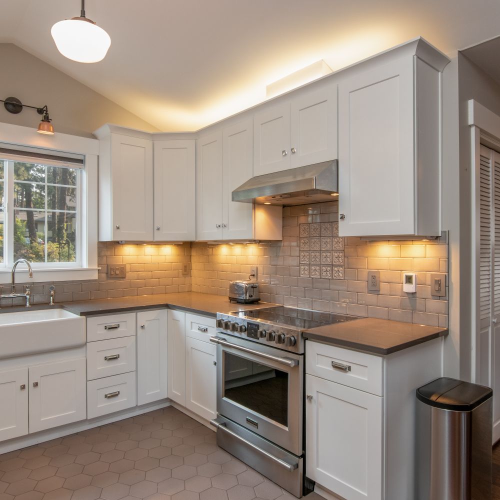 Kitchen Spraying in South Wimbledon — careful masking before painting begins