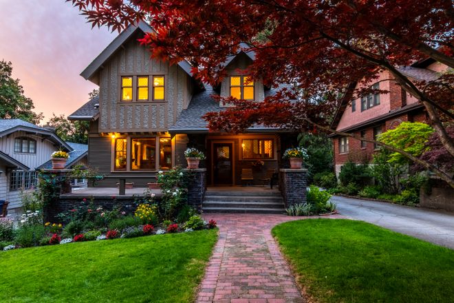 Suburban house with a lush front garden at dusk — photo by Clay Elliot on Pexels