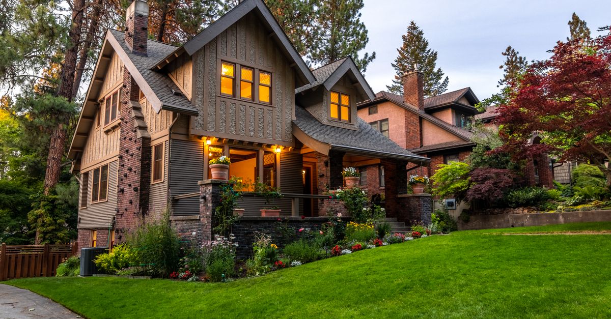 Craftsman home at dusk with warm glowing windows