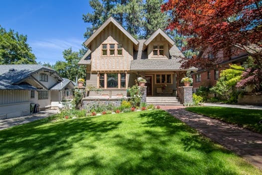Stunning Victorian home with a manicured lawn and vibrant landscaping.
