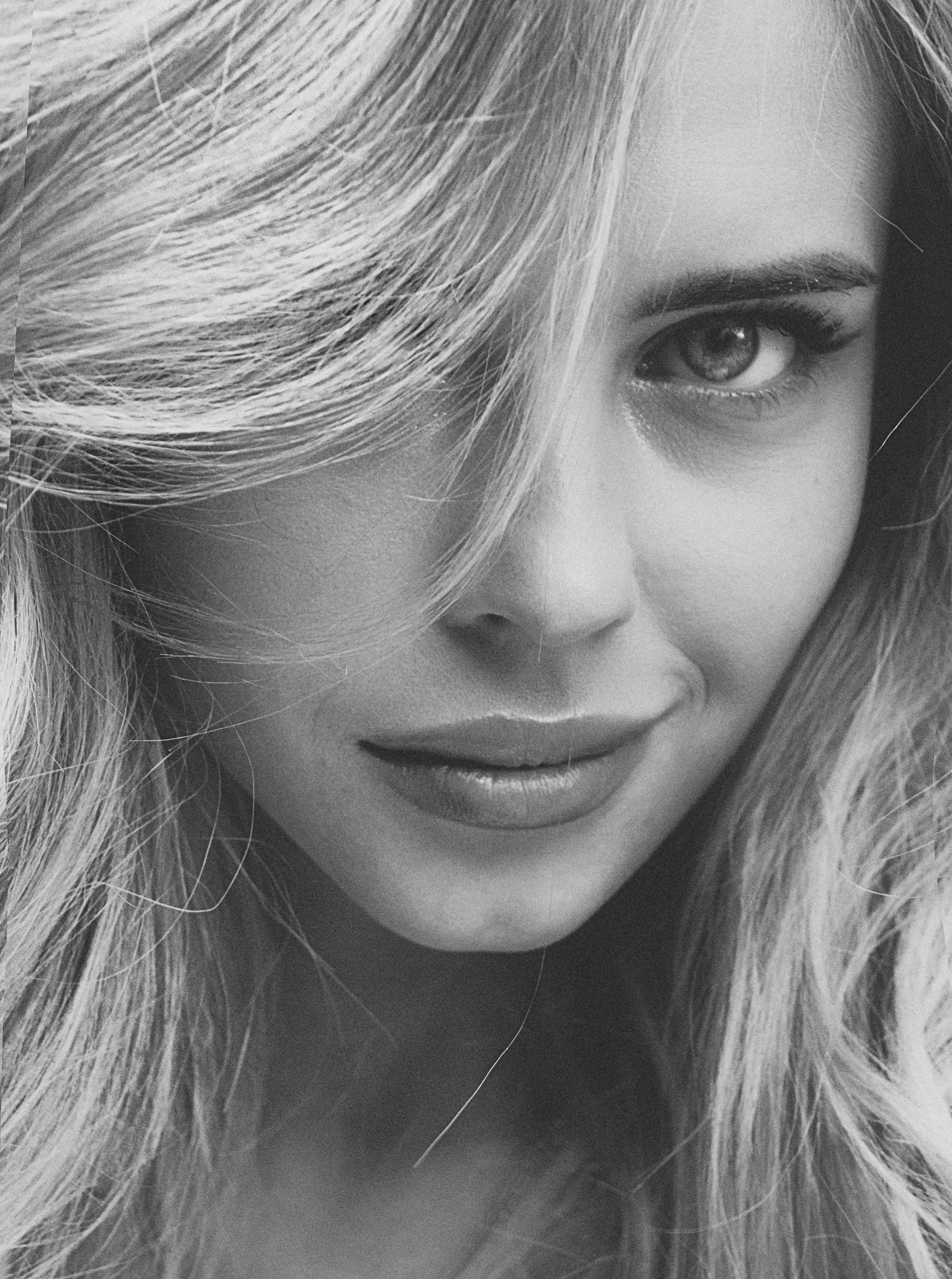 Close-up monochrome portrait of a woman with intense gaze, Kyiv.