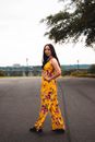 Young Woman in Summer Overalls on Road