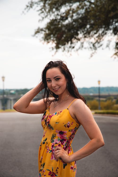 A Woman Posing in Her Yellow Floral Dress