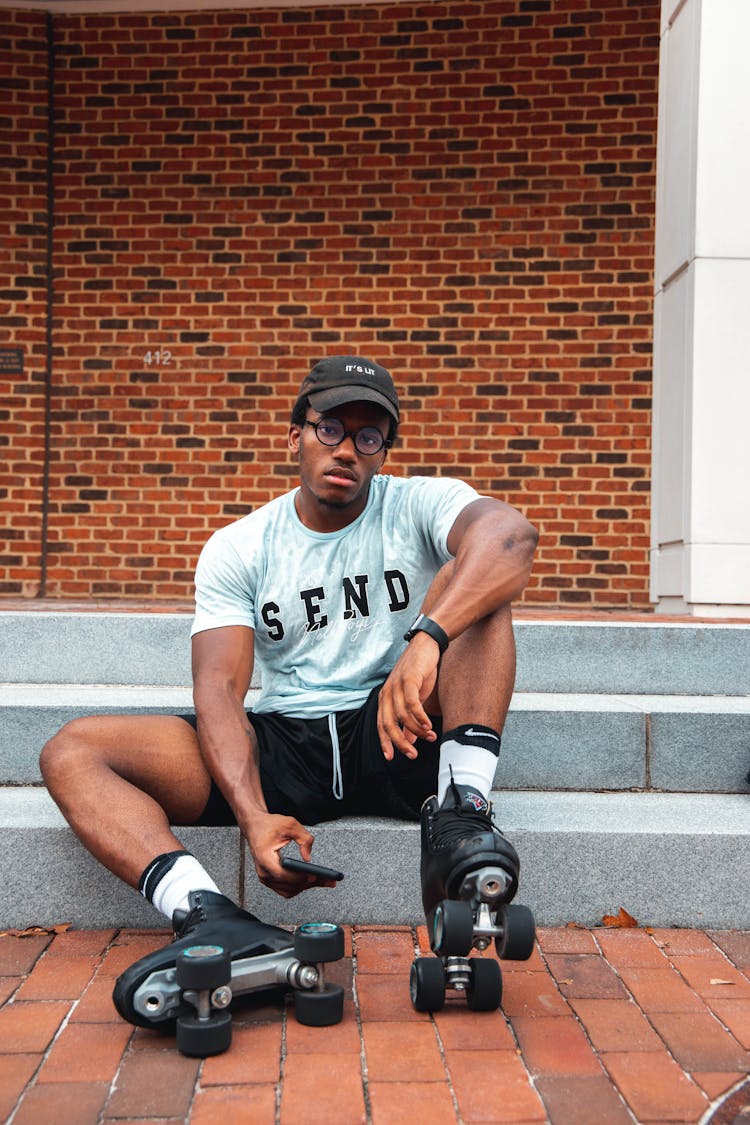 A Roller Skater Sitting On A Step 