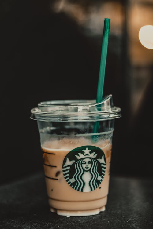 A Starbucks Coffee Cup With Green Straw