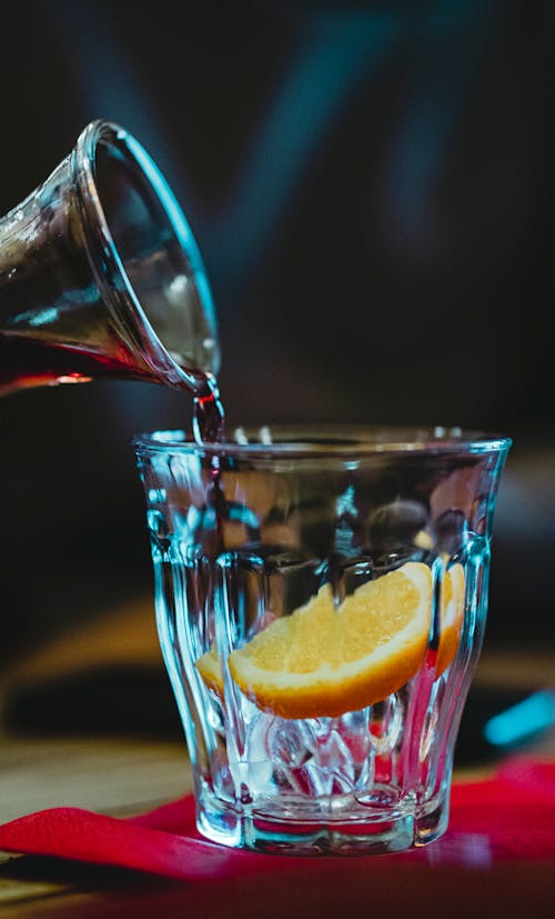 Poring Drink on a Glass with a Slice of Orange Fruit