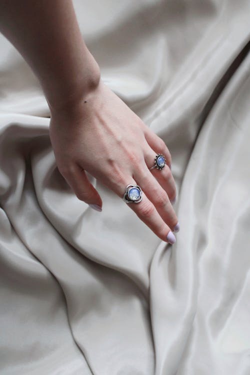 Close up of a Hand Touching a White Fabric