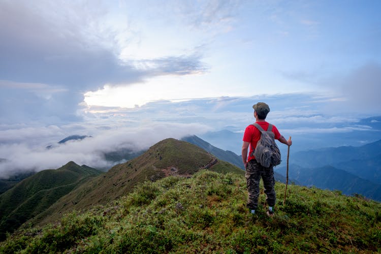 Man Standing On Mountain Peak Hiking