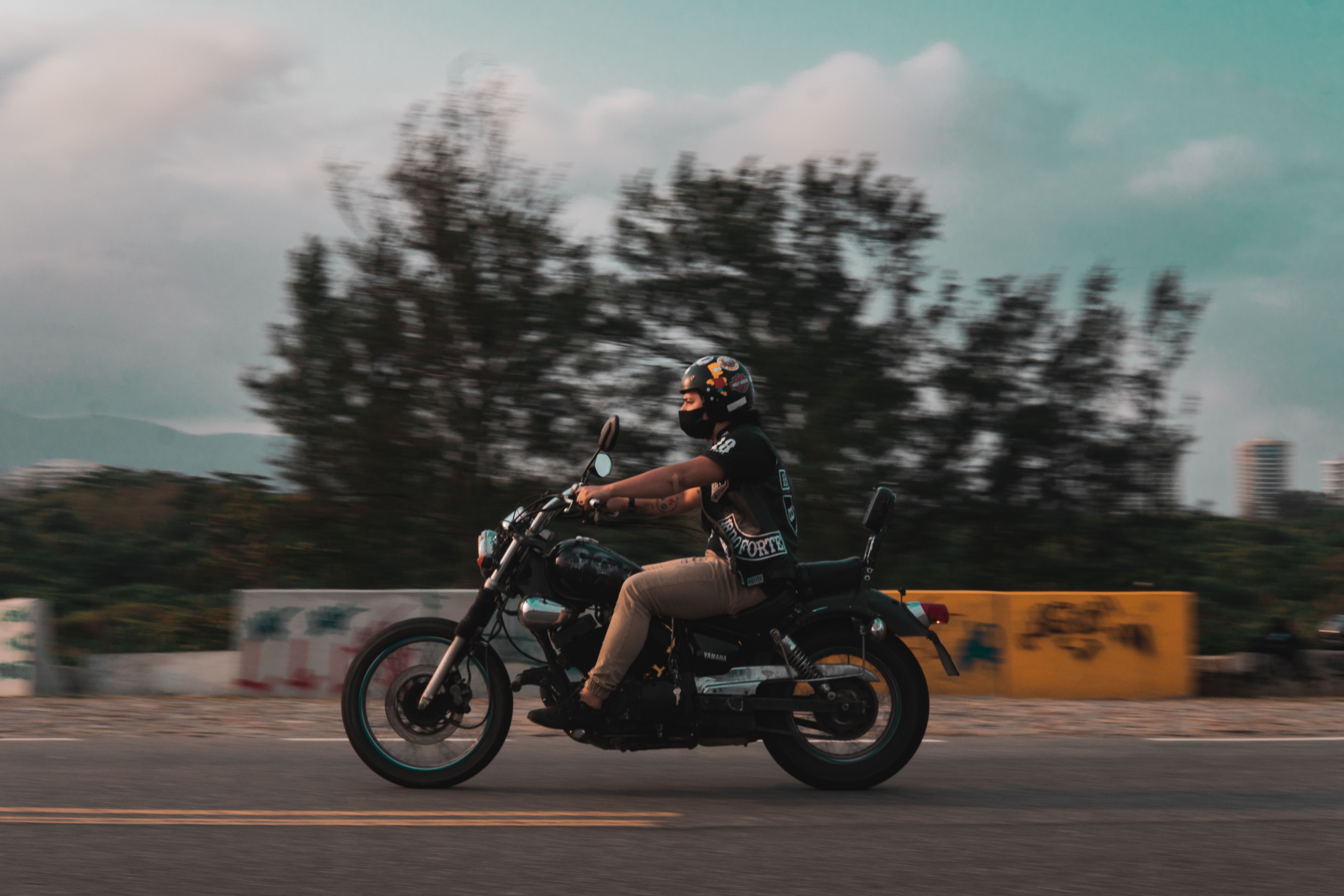 Man Riding a Motorcycle on a Street · Free Stock Photo