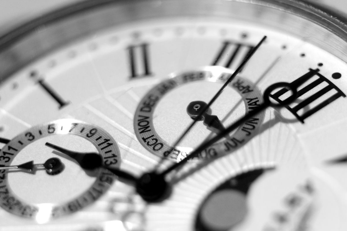 Clock detail with metal hands and minimal numerals