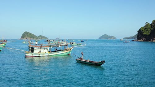 Fishing Boats on Sea Water under the Sky