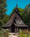 Brown and Gray Concrete Church Near Green Trees Under Blue Sky