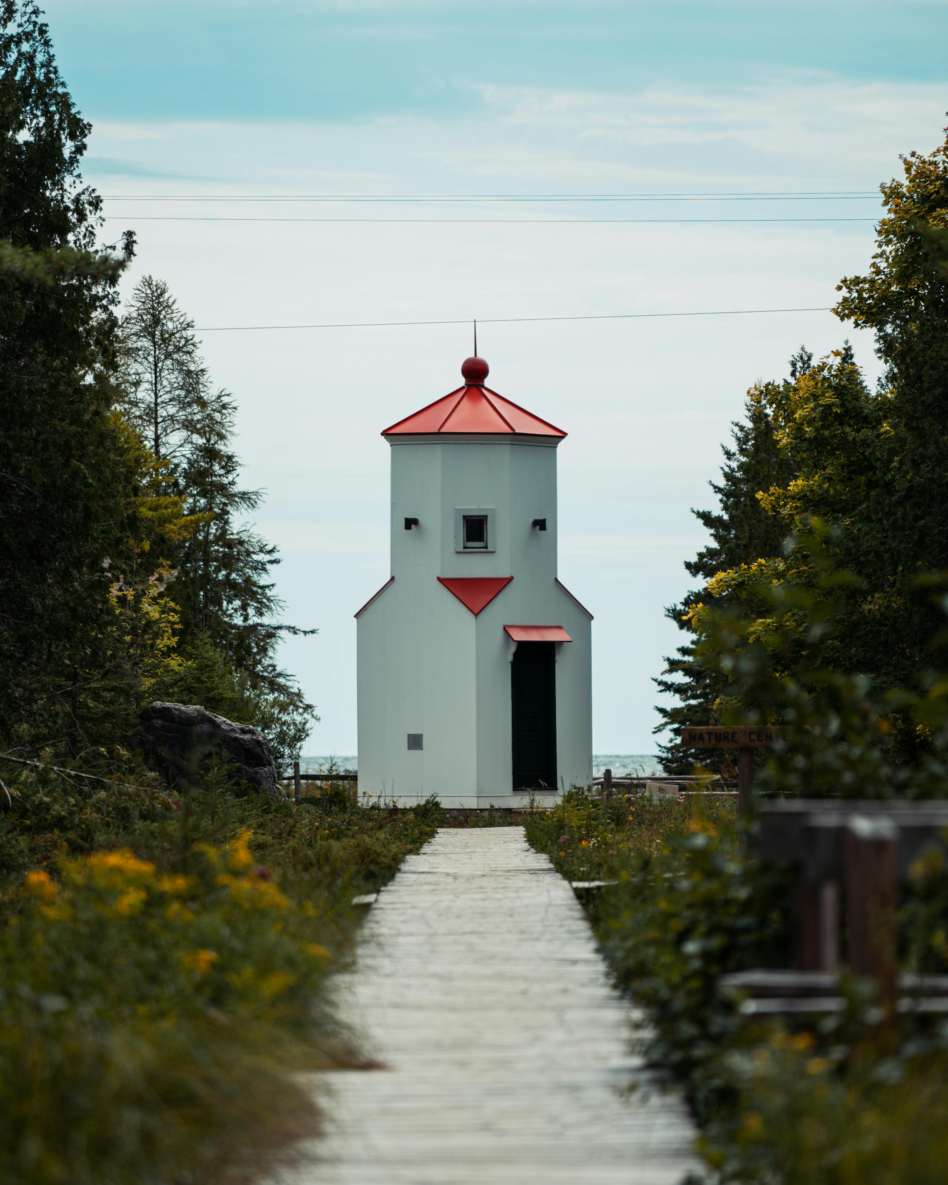 White And Red Concrete Building Near Green Trees Under Blue Sky · Free ...