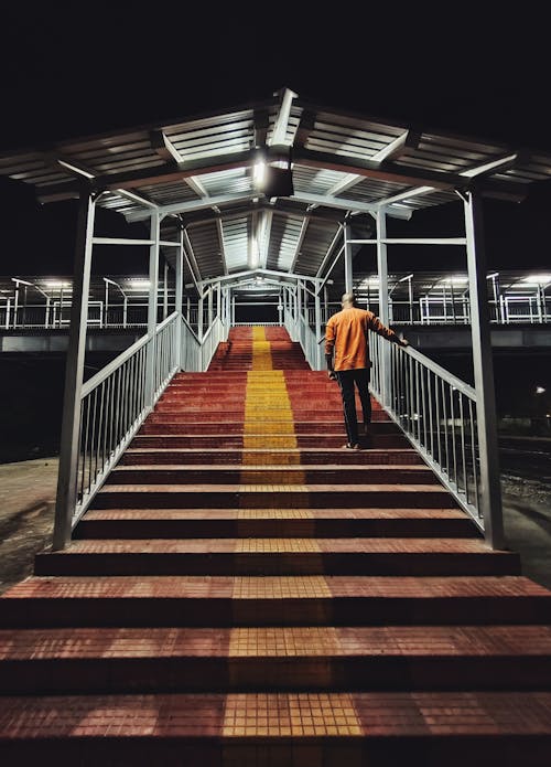 Free Man Walking on Stairs at Night  Stock Photo