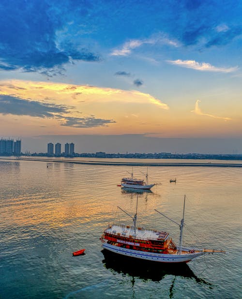 Aerial Photography of Boats on Sea Water during Sunset