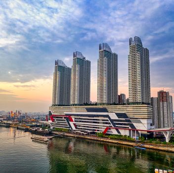 Aerial view of modern skyscrapers in Jakarta, Indonesia, at sunrise reflecting on water. - Fotografer Sidoarjo