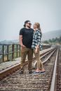 Man and Woman Standing on Train Rail
