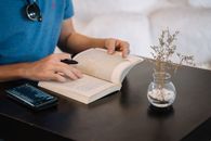 Person in Blue Shirt Reading Book