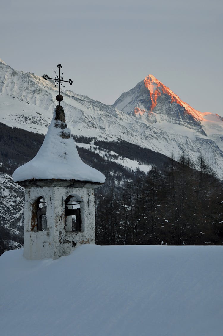 Snow Covered Roof And Mountain