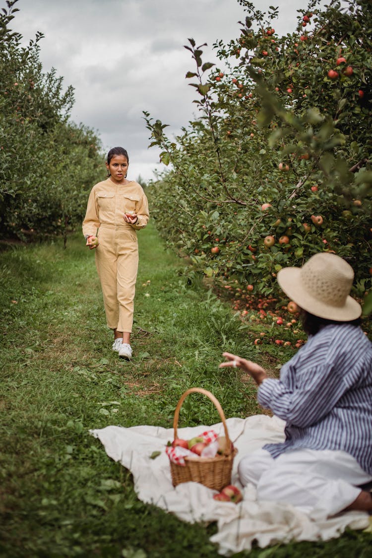 Ethnic Girl Walking To Mother In Garden While Talking