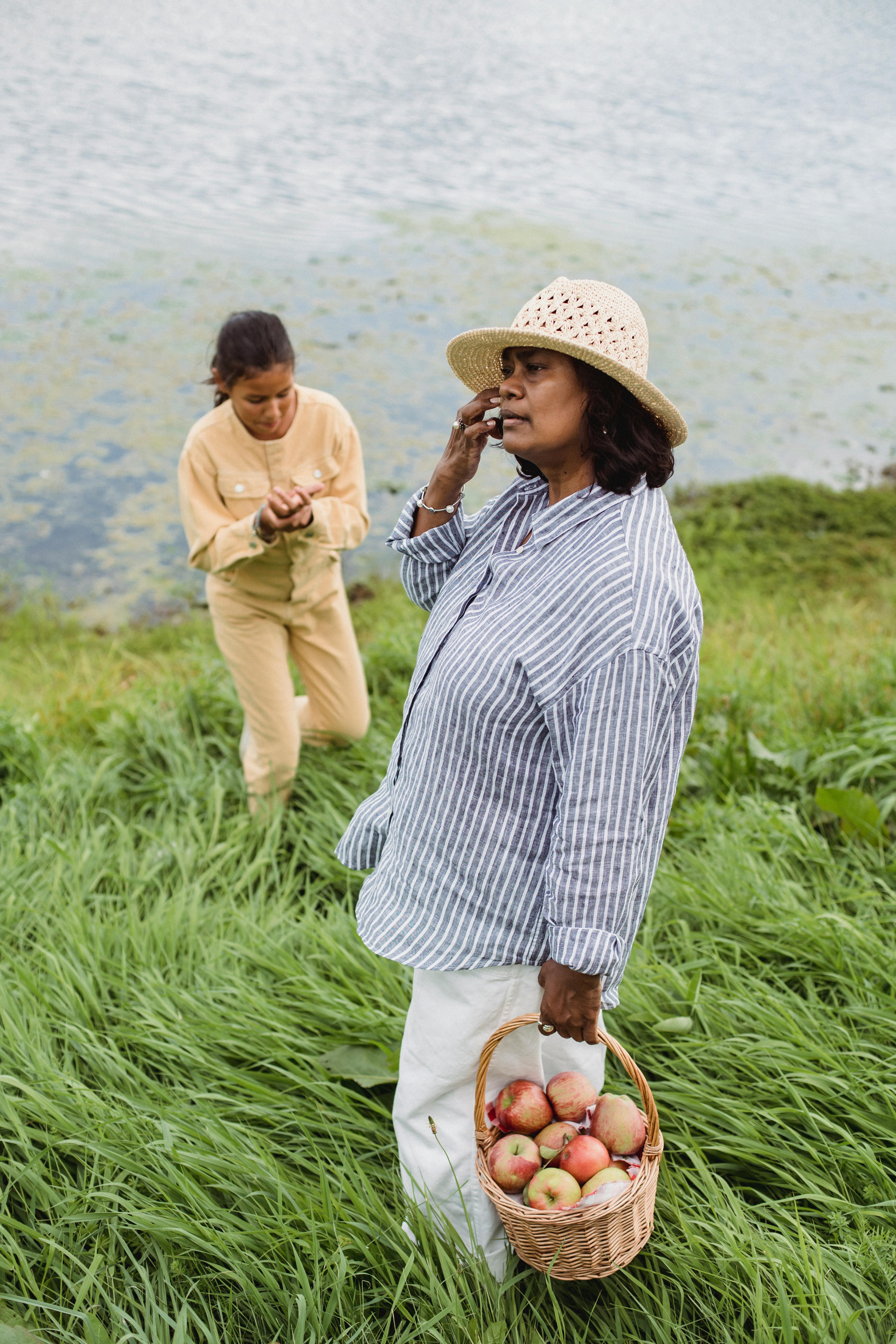 hispanic woman and teen girl near lake