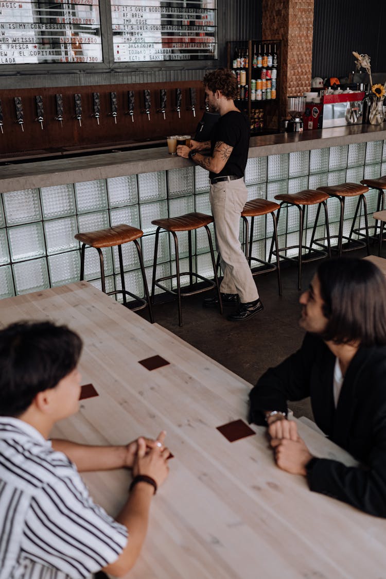 Friends Waiting For Beer In A Restaurant 