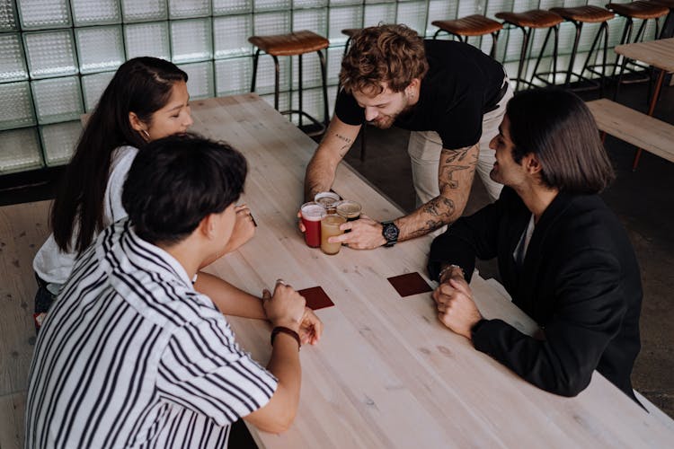 Waiter Serving Customers In A Restaurant