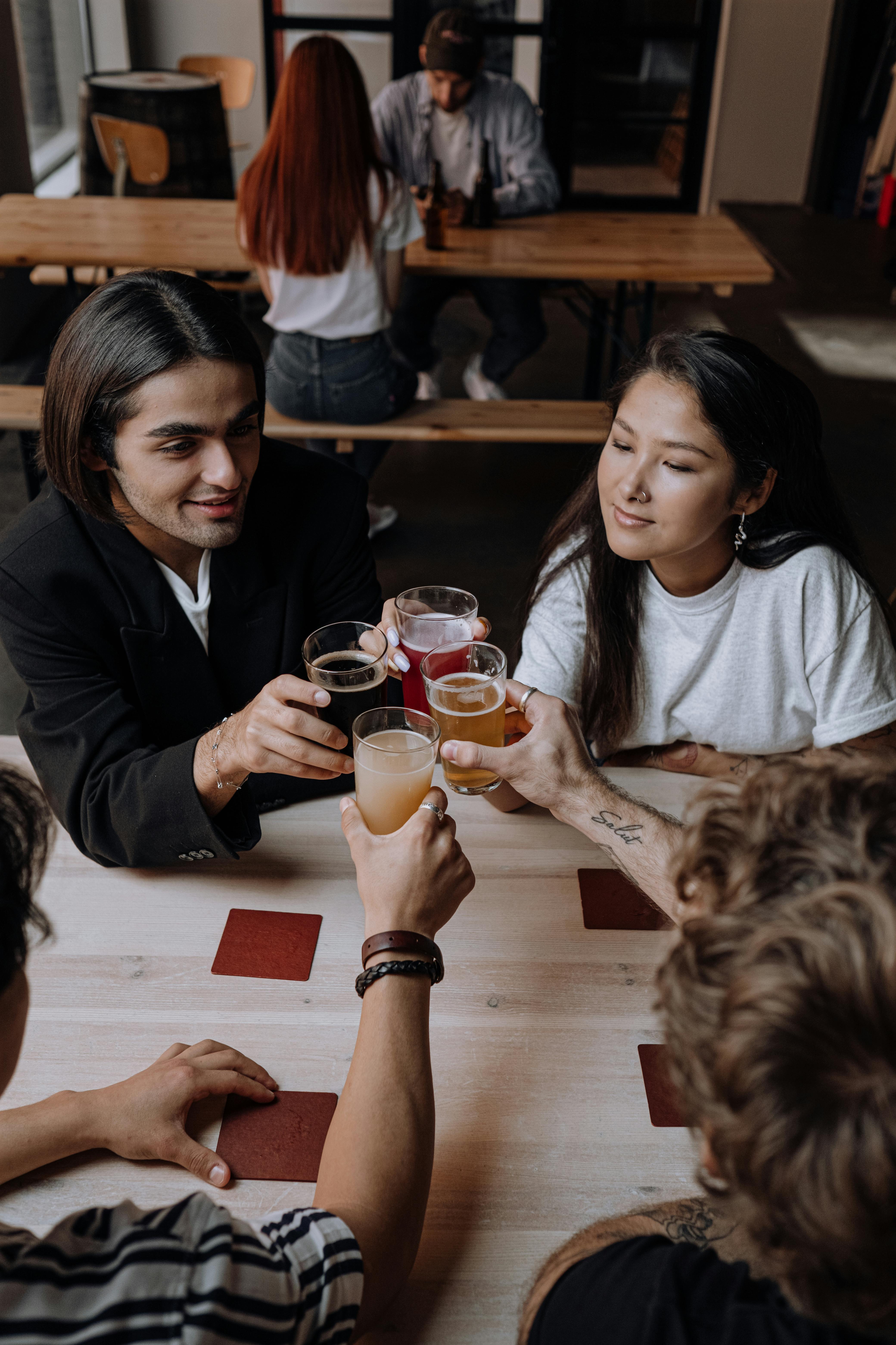 photograph of a group of friends doing a toast with their drinks