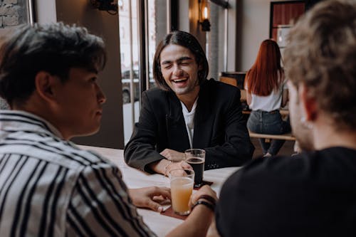 Man in Black Blazer Holding Clear Drinking Glass