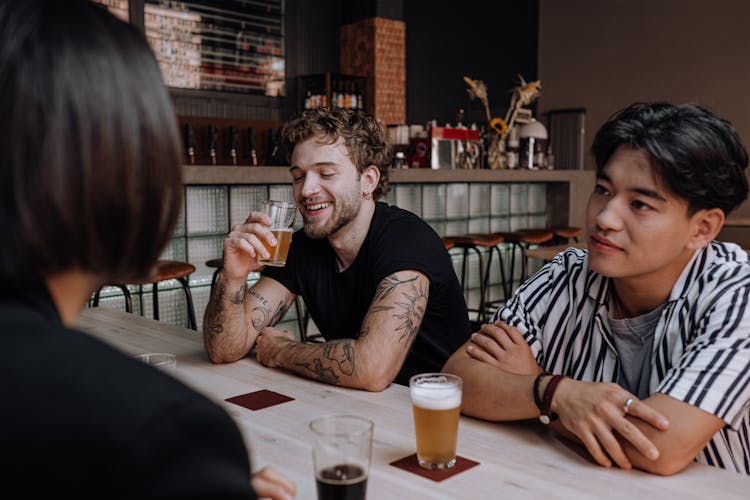 Photograph Of Men Drinking Beer Together