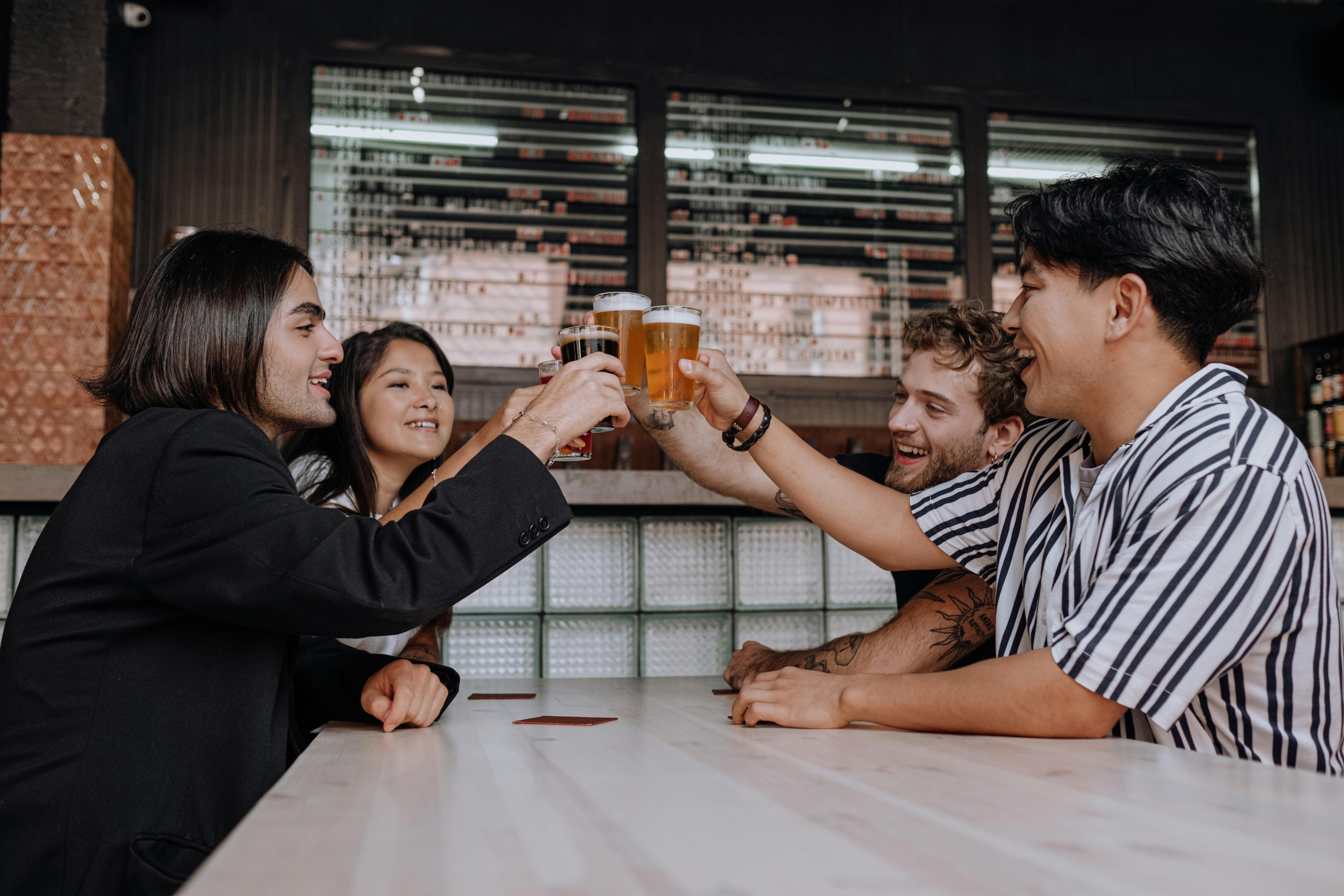 photo of a people doing a toast at the bar