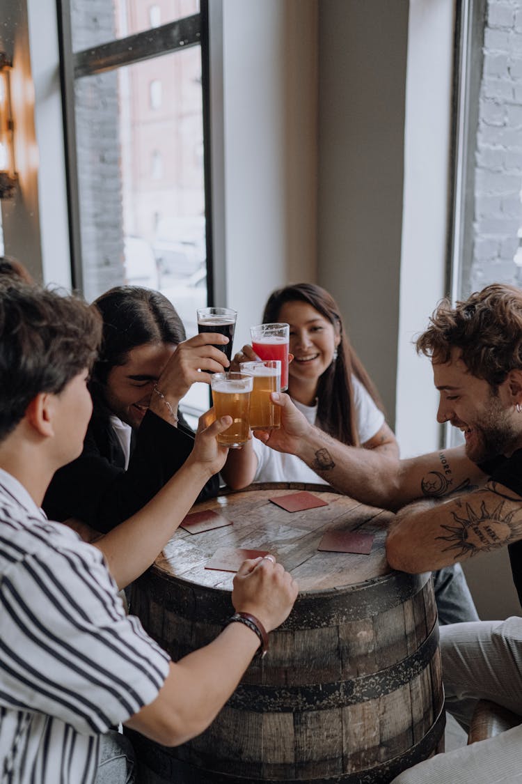 Photograph Of A Group Of Friends Holding Their Drinks