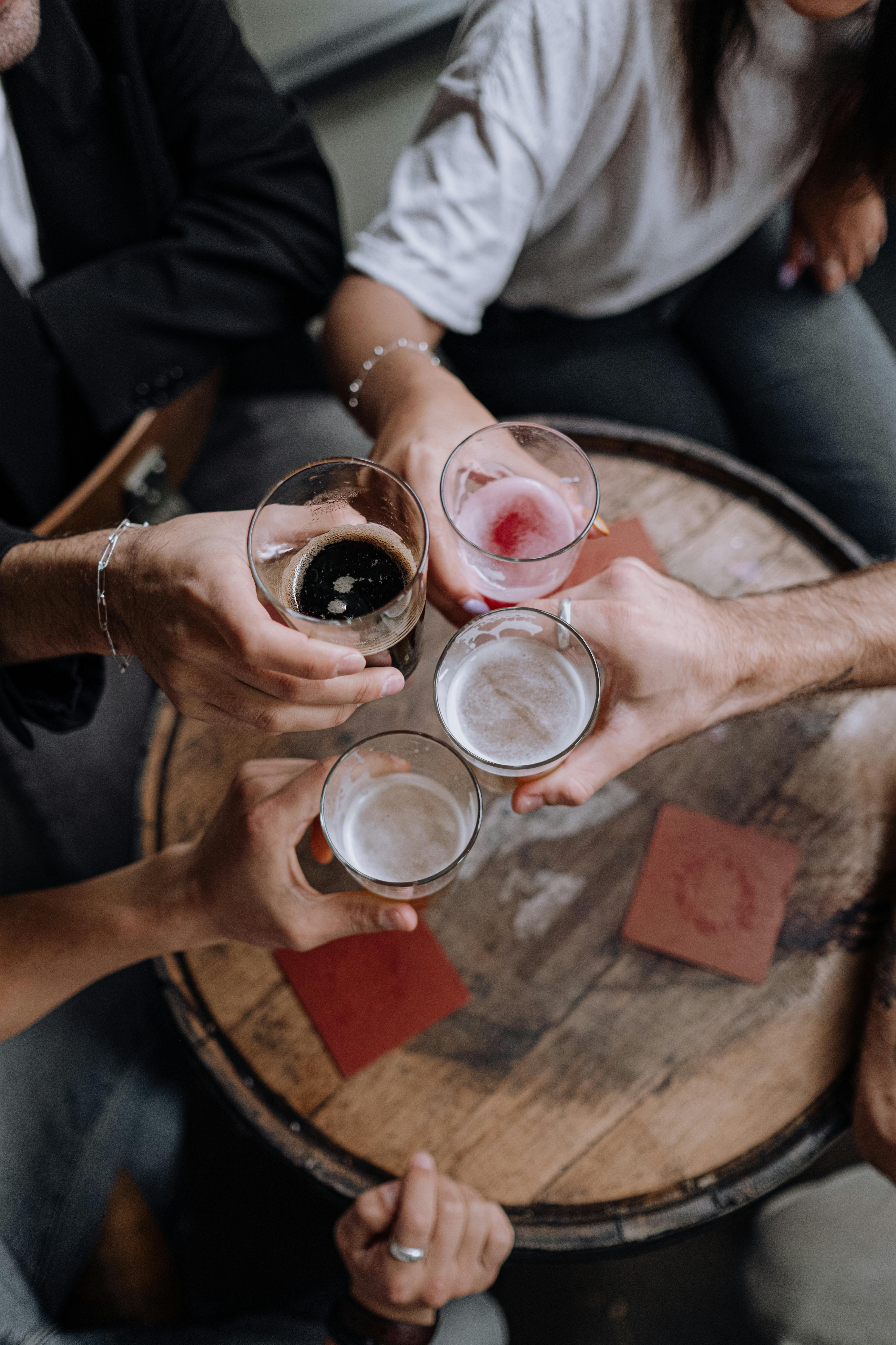 overhead shot of people s hands doing a toast