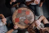 Person Holding Round Brown Wooden Seat
