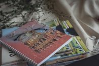 眼镜很适合学习或休闲，就放在一堆书和笔记本上