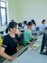 Girls Sitting in Front of the Computers in the Classroom