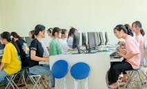 Girls Sitting on Chairs in Front of the Computers