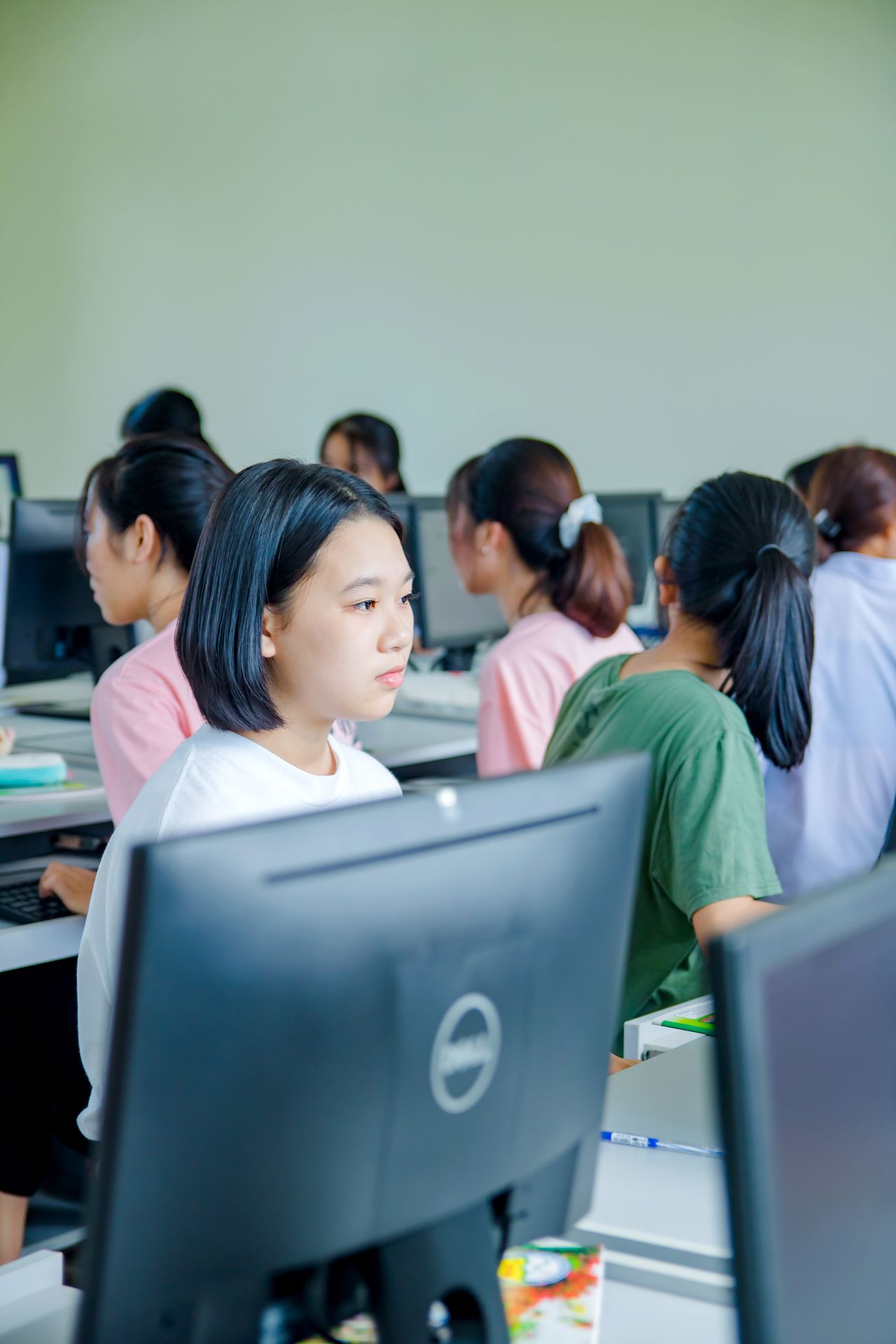 Students focused on learning in a modern computer lab setting.