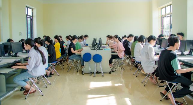 Students engaging in a group study session at a university computer lab, focused and collaborative.