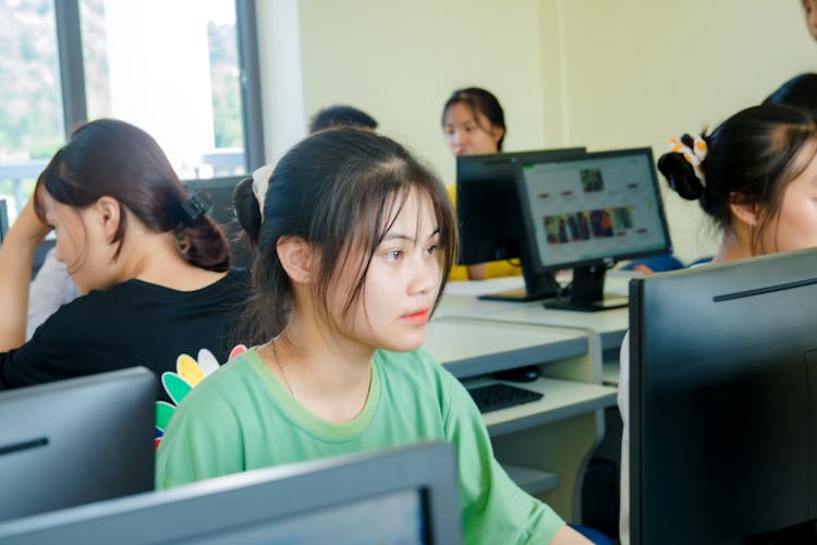 Students Studying On Computers In Classroom