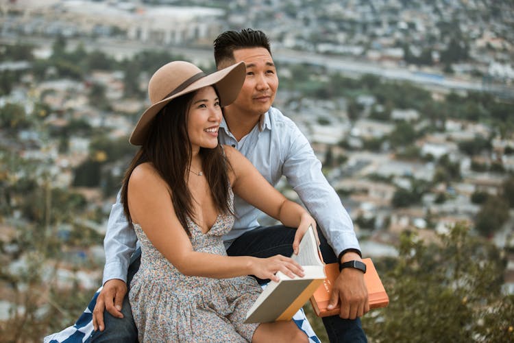 Man And Woman Holding Books