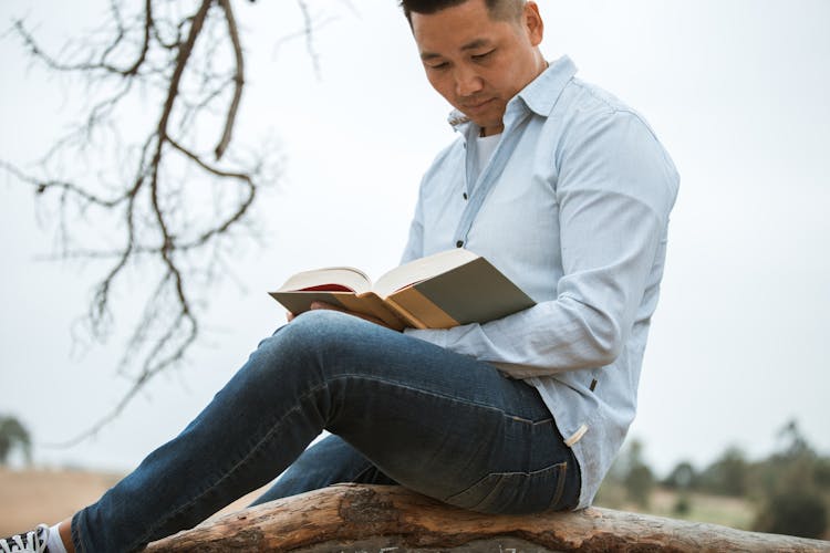 A Man Wearing Reading A Book