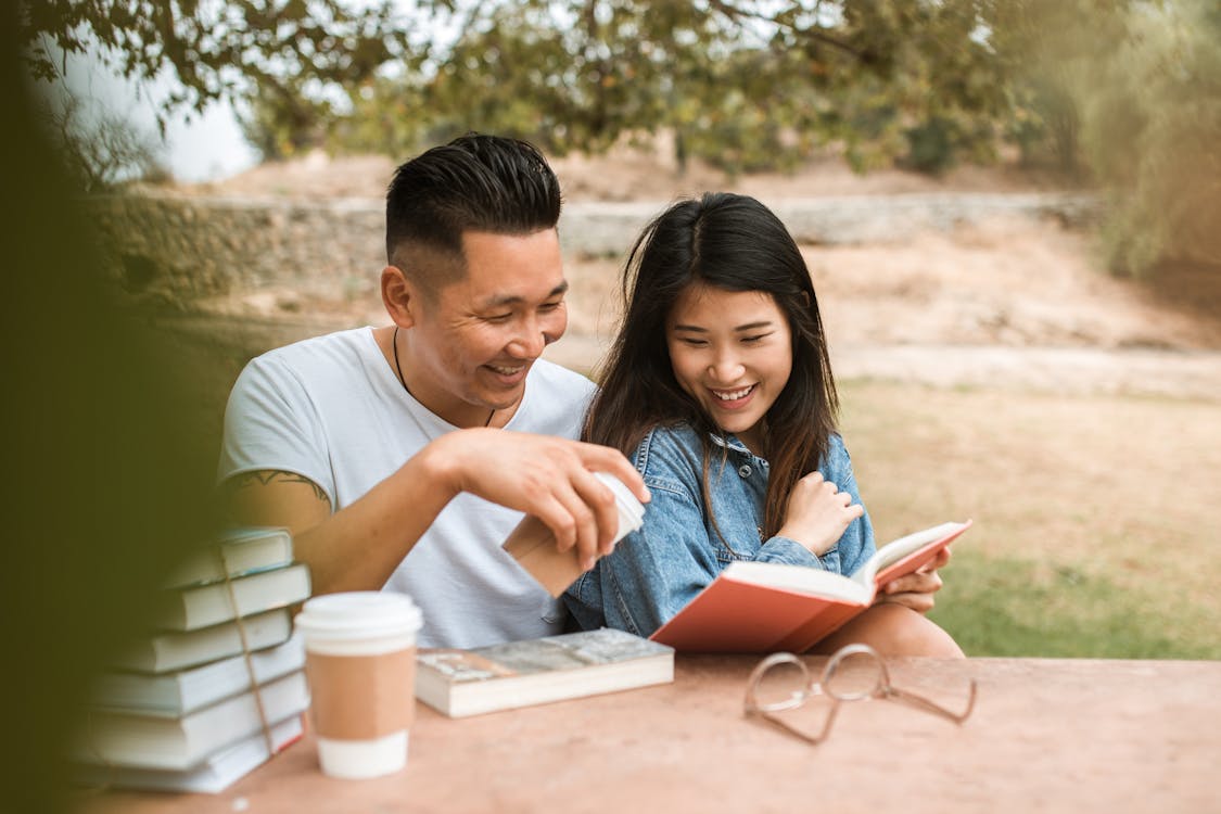 Free A Couple Reading Book Together  Stock Photo