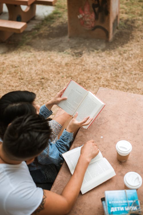 Free Photograph of a Couple Reading a Book Together Stock Photo