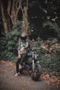 Man in Helmet in Sitting on Motorcycle in Forest